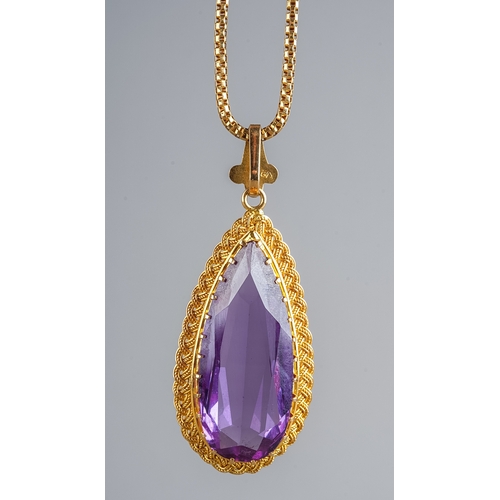 88 - A 18k yellow gold and synthetic colour change sapphire pendant necklace, the large pear cut stone ap... 