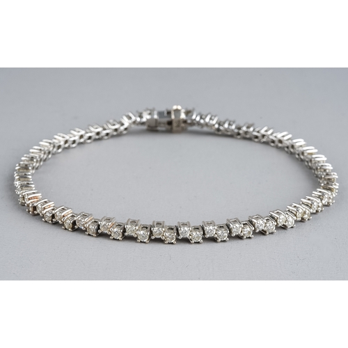 93 - An 18ct white gold and diamond line bracelet, set with 80 round brilliant cut diamonds, each approx ... 