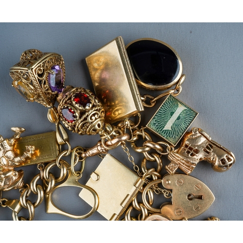 94 - A heavy 9ct yellow gold charm bracelet, the curb-link bracelet suspending a 1903 sovereign mounted i... 