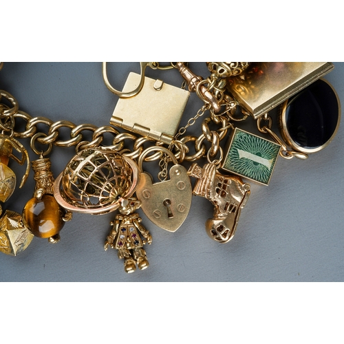 94 - A heavy 9ct yellow gold charm bracelet, the curb-link bracelet suspending a 1903 sovereign mounted i... 