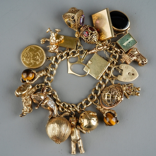 94 - A heavy 9ct yellow gold charm bracelet, the curb-link bracelet suspending a 1903 sovereign mounted i... 