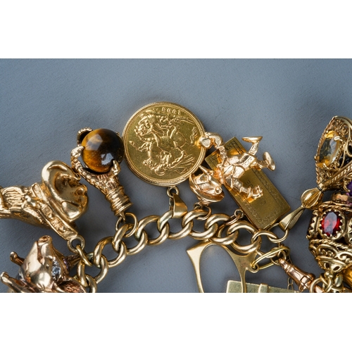 94 - A heavy 9ct yellow gold charm bracelet, the curb-link bracelet suspending a 1903 sovereign mounted i... 