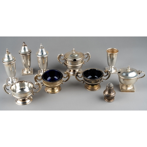 128 - A set of three silver open salts and a mustard pot and cover, Chester 1904, three with blue glass li... 