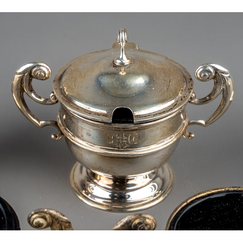 128 - A set of three silver open salts and a mustard pot and cover, Chester 1904, three with blue glass li... 