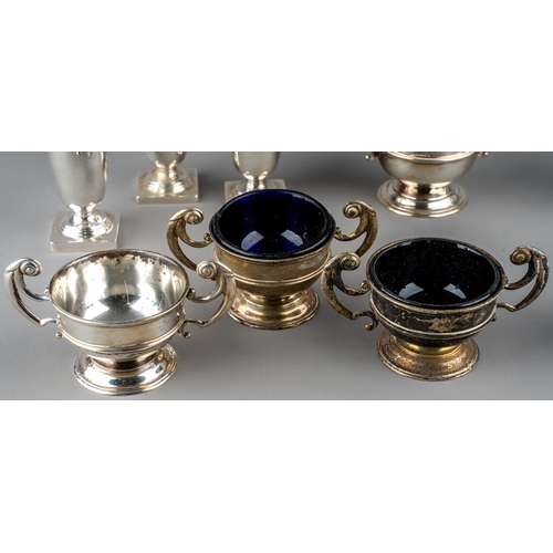 128 - A set of three silver open salts and a mustard pot and cover, Chester 1904, three with blue glass li... 