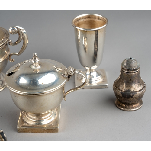 128 - A set of three silver open salts and a mustard pot and cover, Chester 1904, three with blue glass li... 