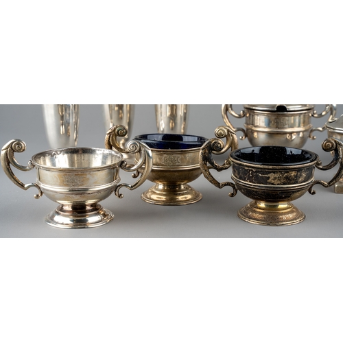 128 - A set of three silver open salts and a mustard pot and cover, Chester 1904, three with blue glass li... 