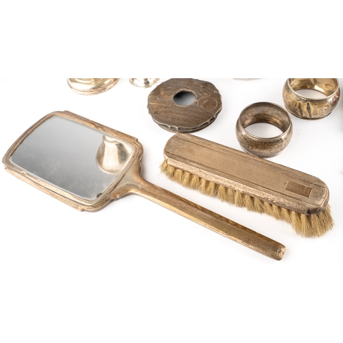 129 - A collection of silver, including napkin rings, dressing table brush and mirror, etc, a set of four ... 