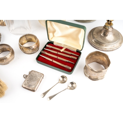 129 - A collection of silver, including napkin rings, dressing table brush and mirror, etc, a set of four ... 