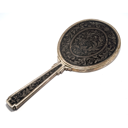 130 - An Art Deco silver hand mirror, the reverse chased with foliate scrolls, makers mark R.C., London 19... 