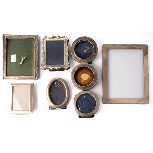 131 - A collection of silver photograph frames, including round, oval and rectangular