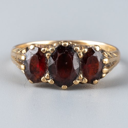 162 - A 9ct yellow gold and garnet dress ring, set with three oval cut stones, ring size O, total gross we... 