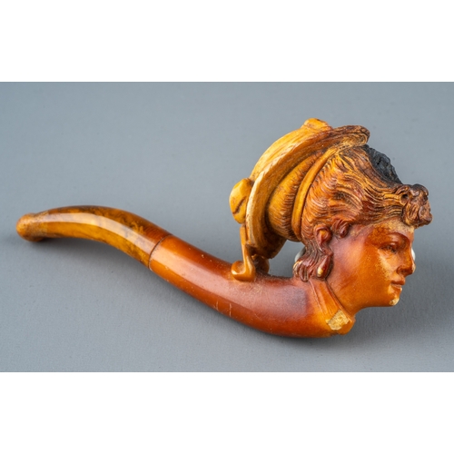 163 - A late 19th/early 20th century Meerschaum pipe, carved as a profile of a lady wearing a bonnet, ambe... 