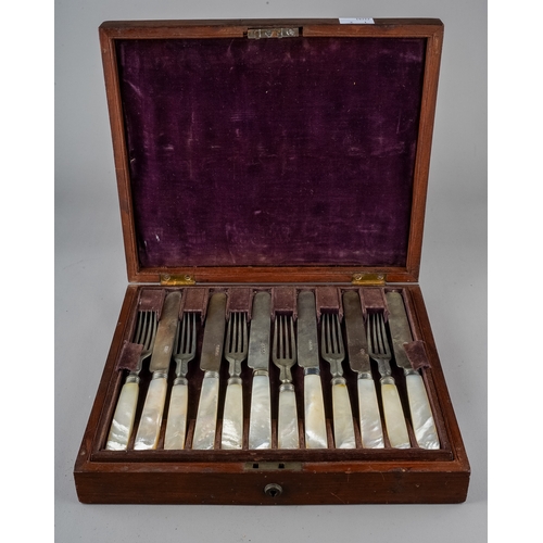 212 - A late 19th Century set of twelve fruit knives and forks with mother of pearl handles, plated blades... 