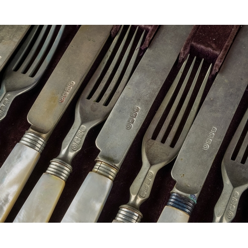 212 - A late 19th Century set of twelve fruit knives and forks with mother of pearl handles, plated blades... 