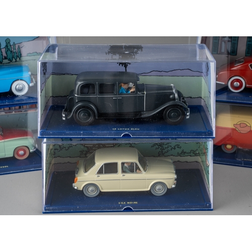 240 - A collection of Tintin Herge Moulinsart die cast models, all in perspex case with background design ... 