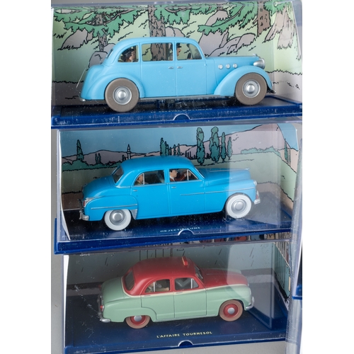 240 - A collection of Tintin Herge Moulinsart die cast models, all in perspex case with background design ... 