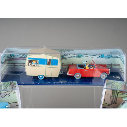 240 - A collection of Tintin Herge Moulinsart die cast models, all in perspex case with background design ... 