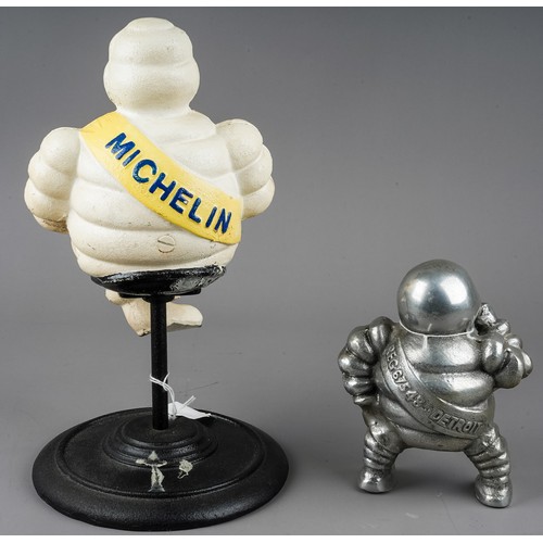 278 - A cast metal model of a revolving Michelin man, with yellow sash, approx 30cm high and a chrome mode... 