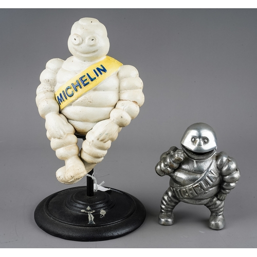 278 - A cast metal model of a revolving Michelin man, with yellow sash, approx 30cm high and a chrome mode... 