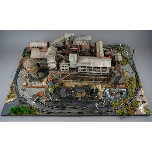 298 - A model railway N gauge layout board containing diorama depicting coal mine processing plant with fi... 