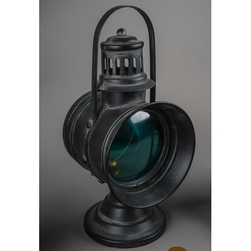 303 - A vintage black lantern lamp with bevelled glass panels, carrying handle, approx 23cm high together ... 