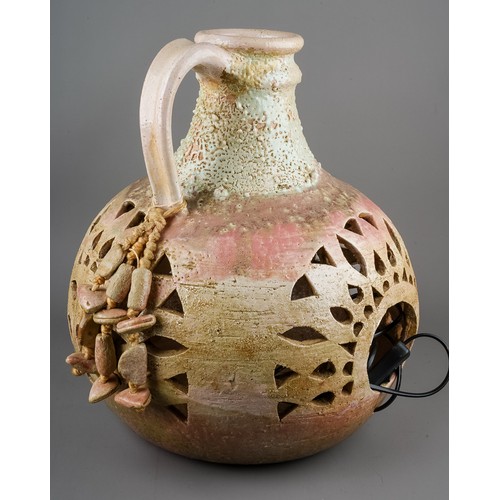 306 - A very large terracotta bottle lamp; together with a lamp designed as a globe (2)