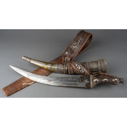 338 - A 19th century Wahabi Jambiya dagger which is mounted in silver and brass with leather belt, tt poss... 