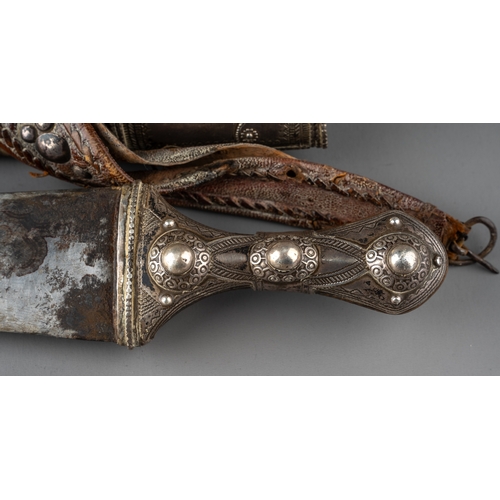 338 - A 19th century Wahabi Jambiya dagger which is mounted in silver and brass with leather belt, tt poss... 