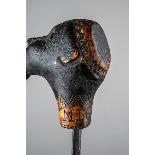 344 - An unusual tribal carved sword stick, in the form of a man with something in his mouth, incised carv... 