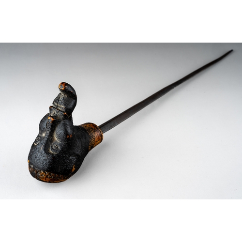 344 - An unusual tribal carved sword stick, in the form of a man with something in his mouth, incised carv... 