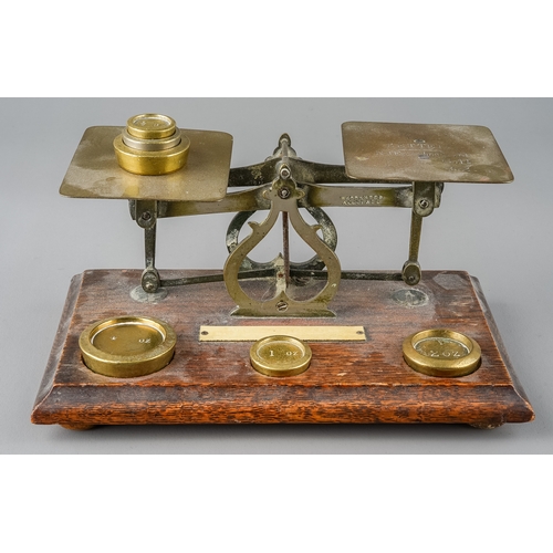 354 - A pair of vintage postal scales with various weights