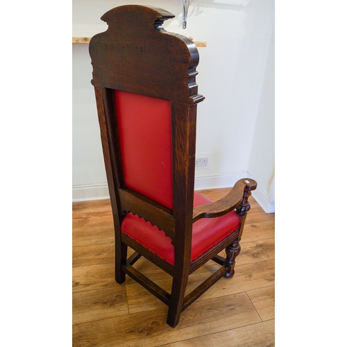 363 - A Gothic style carved oak throne chair, red leather seat and backing, with carved lettering on the h... 