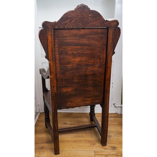 366 - A Victorian oak Wainscot chair, carved arched back, scrolled arms, boarded seat, turned legs and rai... 