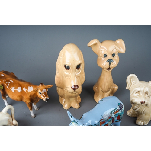 401 - A collection of ceramic animals to include: John Beswick Jersey cow; Beswick Owl, Modern Lowry Cow a... 