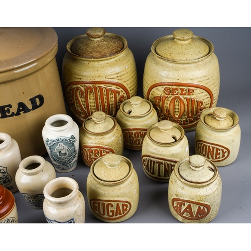 403 - A collection of earthenware to include: Victorian style cream jars with transfer printed labels,, al... 