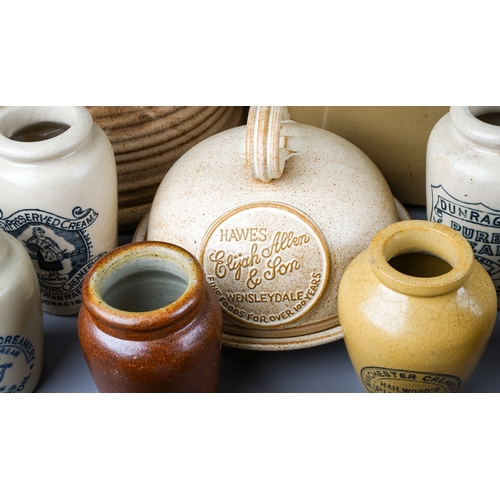 403 - A collection of earthenware to include: Victorian style cream jars with transfer printed labels,, al... 