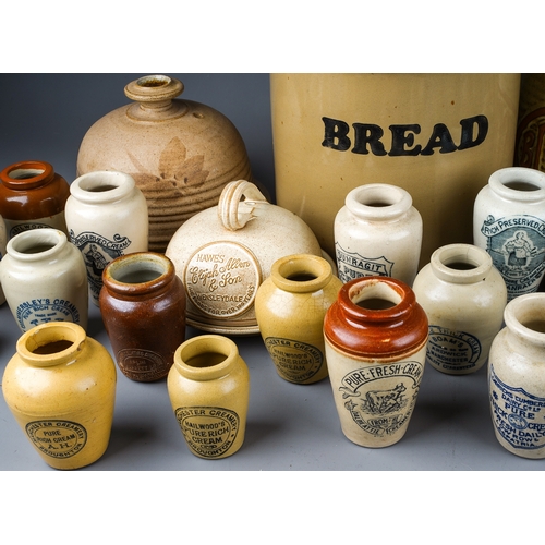 403 - A collection of earthenware to include: Victorian style cream jars with transfer printed labels,, al... 