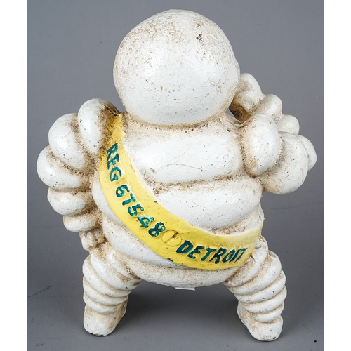 410 - A cast metal Vintage style figure of the Michelin Man, the yellow sash with Reg 67548 Detroit to rev... 