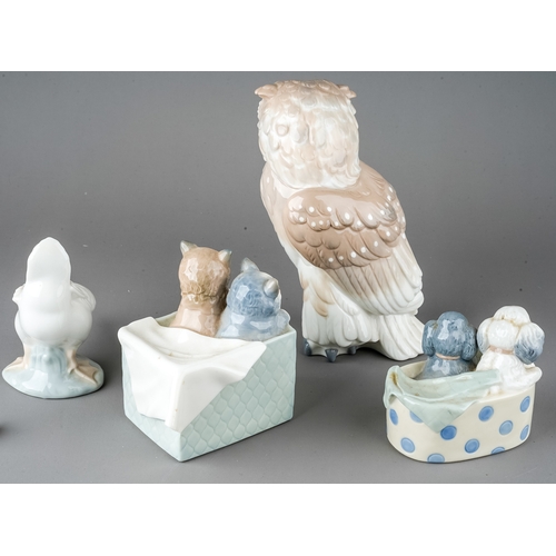 509 - A group of four Nao figures to include: Puppies in basket no: 1082; Cats in a box, no: 1080; Owl no:... 