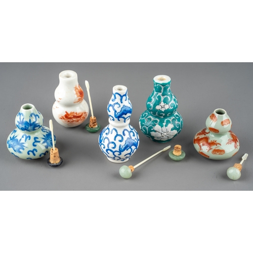 529 - A collection of Chinese porcelain double gourd snuff bottles, including celadon ground, blue and whi... 