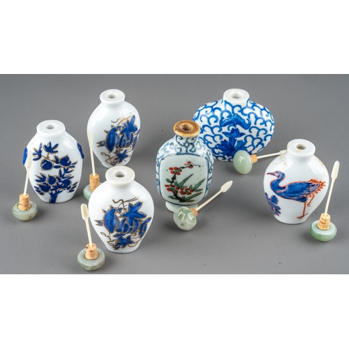 534 - A collection of Chinese porcelain snuff bottles, including a pair of ovoid bottles enameled with blu... 