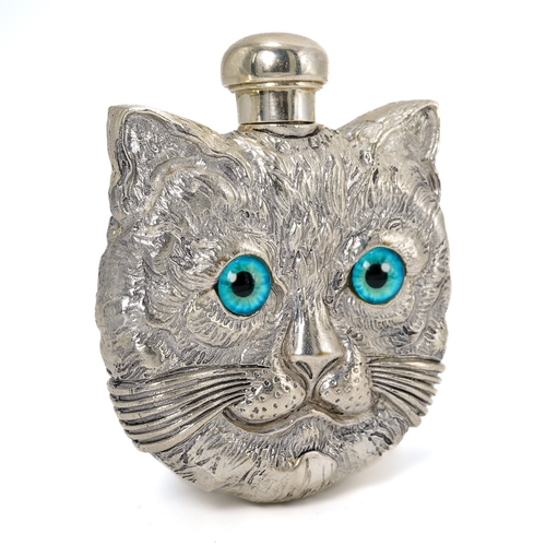 544 - A continental white metal novelty scent bottle, cast both sides as a cat's face with blue glass eyes... 