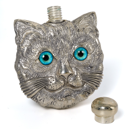 544 - A continental white metal novelty scent bottle, cast both sides as a cat's face with blue glass eyes... 