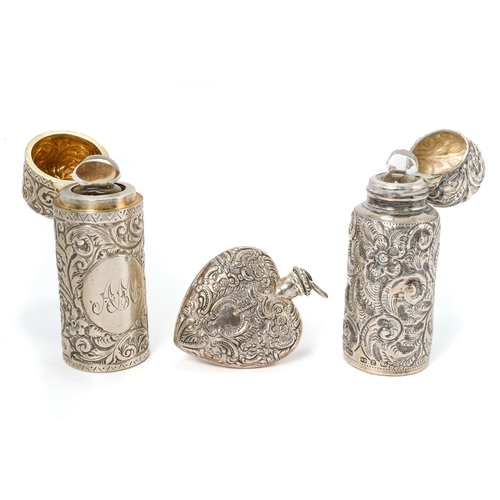 550 - A Victorian cylindrical silver scent bottle, embossed with foliate scrolls, gilt lined, hinged cover... 