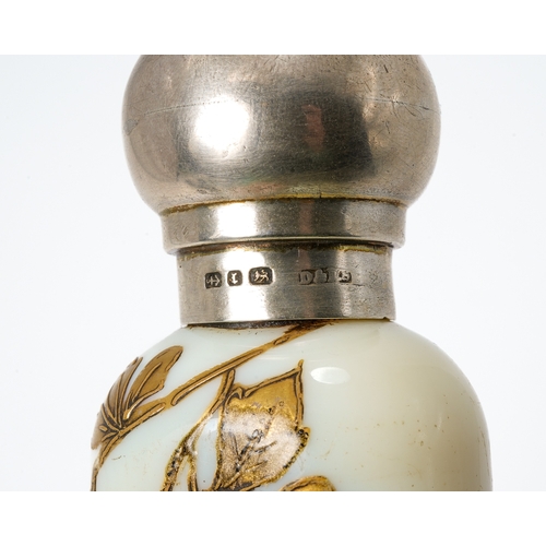 561 - A Victorian silver mounted opaque glass scent bottle, of conical form with gilt foliate detail, silv... 