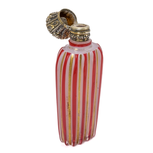 562 - A 19th century milch glass scent bottle, with ruby flash and gilt stripes, silver hinged cover, appr... 