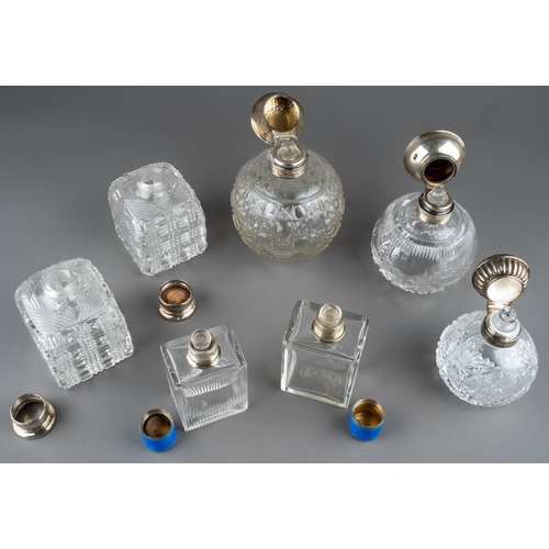 567 - A collection of seven silver mounted cut glass scent bottles, including a matched pair of Art Deco r... 