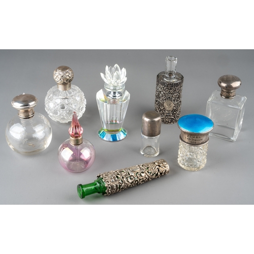 571 - A collection of nine glass scent bottles including two cut glass globular bottles with screw-on silv... 