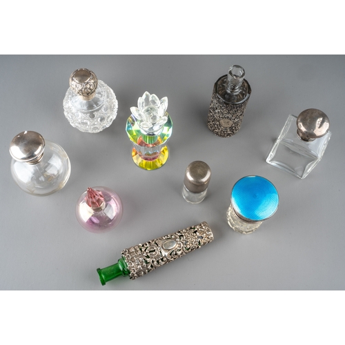 571 - A collection of nine glass scent bottles including two cut glass globular bottles with screw-on silv... 